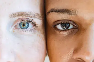 Two people with different skin colours have their heads close together