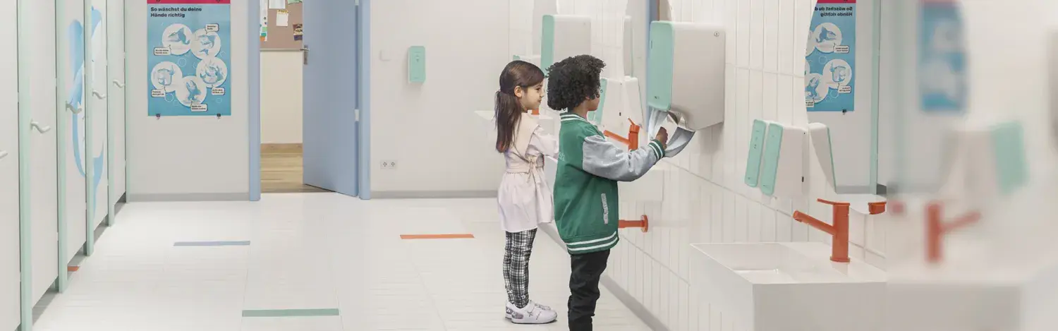 Two children washing hands in elementary school