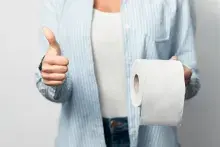 Woman Holding Toilet Paper Gesturing Thumbs-Up