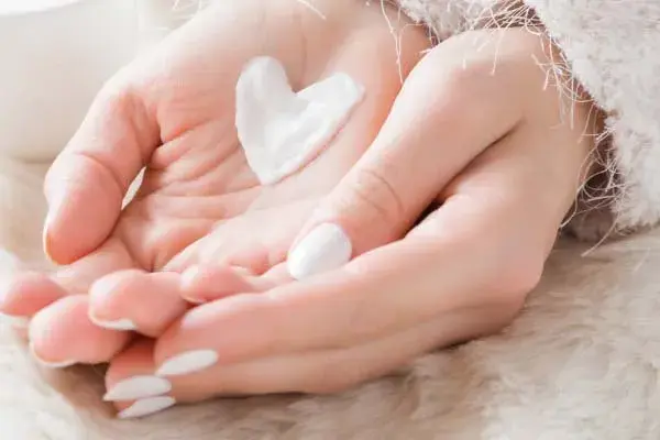 Two groomed hands with skin-friendly products