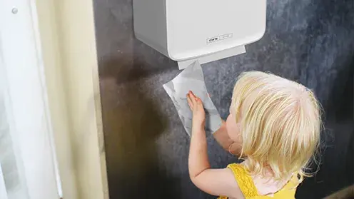 A Child drying hands with a tissue