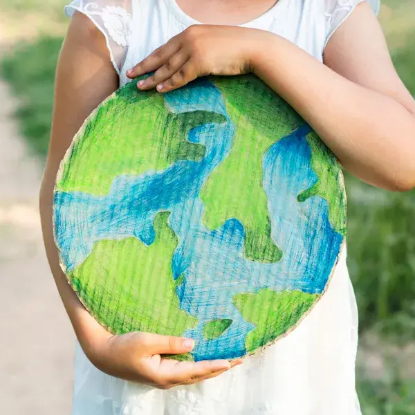 Barn som håller i ett tecknat jordklot