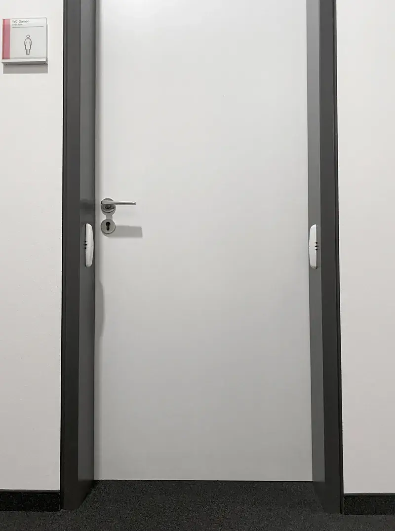 CWS PureLine People counter mounted in a doorframe of a toilet